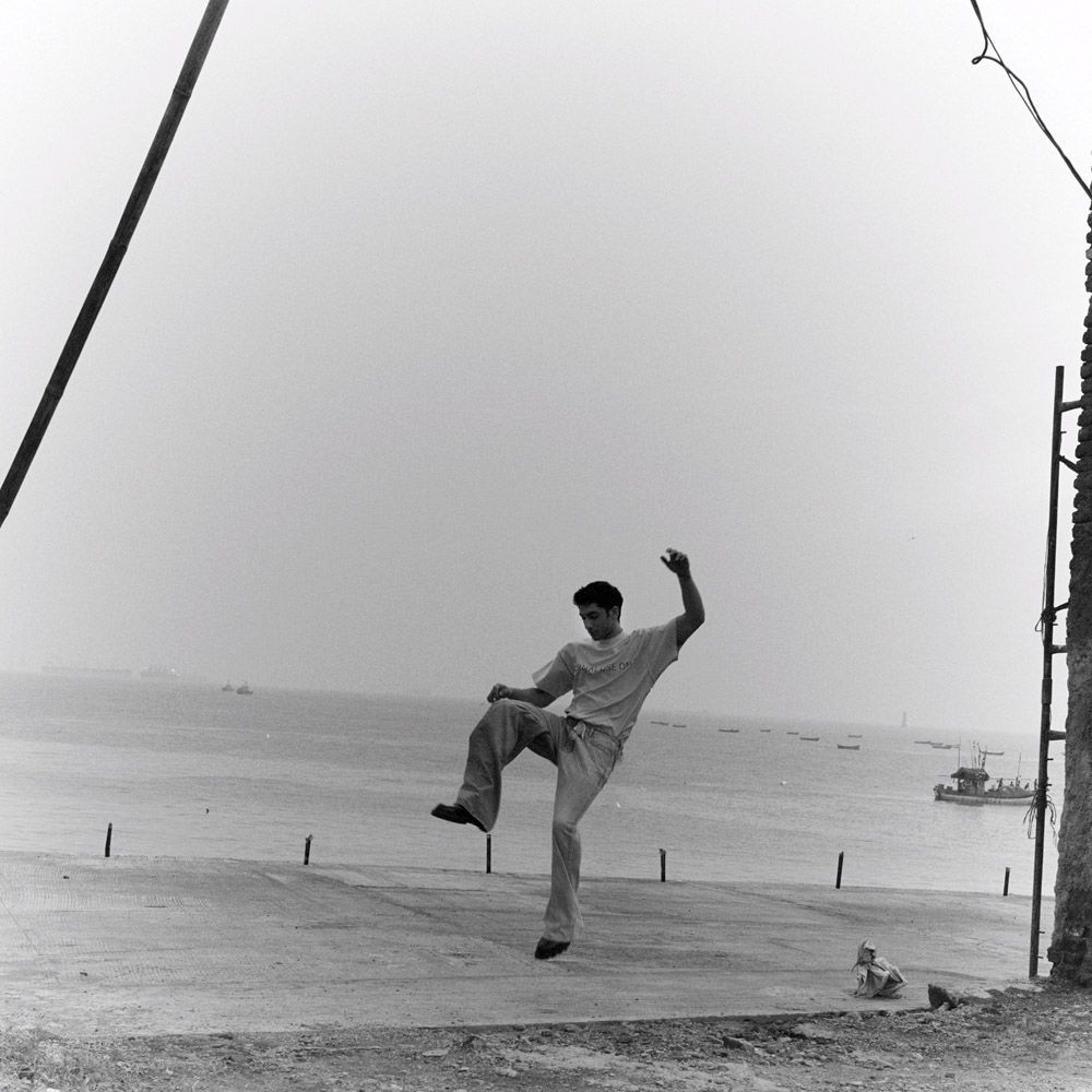 Vedang Raina jumps with the Arabian Sea in the background