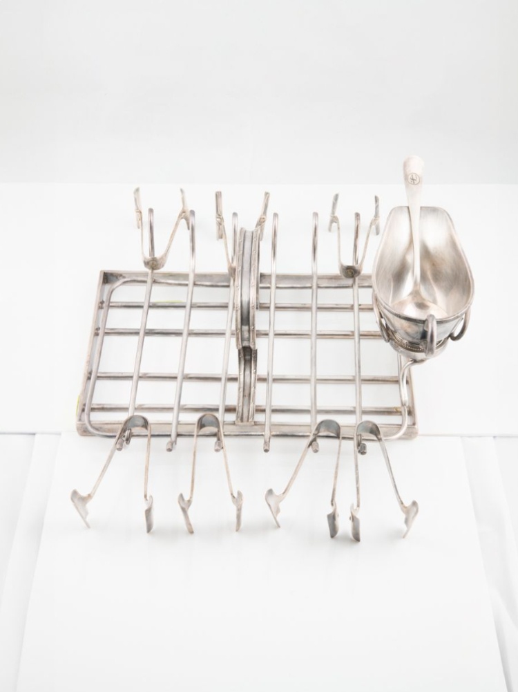 A sterling silver asparagus rack with tongs