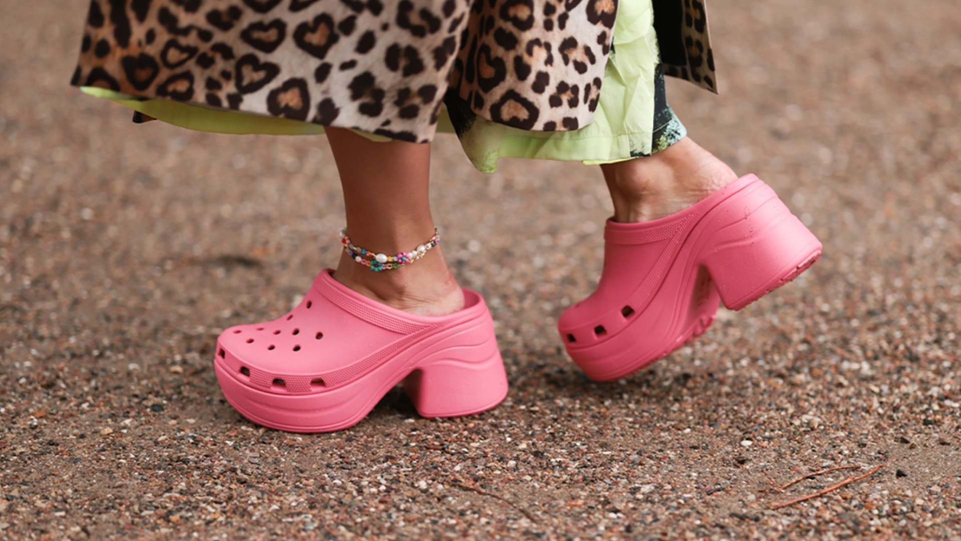 A woman wearing pink platform Crocs