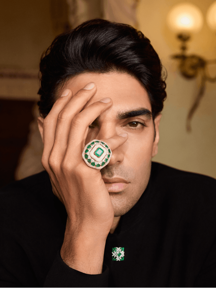 A male model wearing an emerald and diamond ring from Manish Malhotra High Jewellery